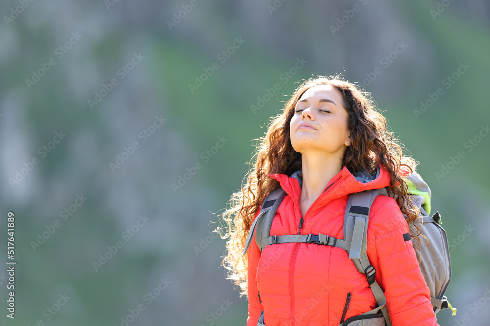 Hiker breathing fresh air in the mountain
