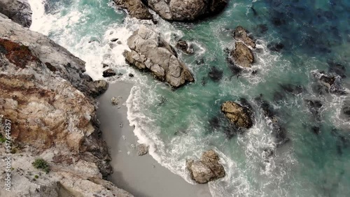 Drone Footage of Big Sur California at Highway One. USA Coastal Road on a sunny day. Beach birds eye view of beach and cliffs.