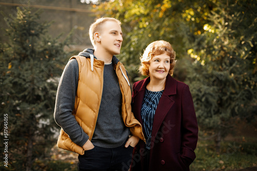 Mom and son look into the distance in the forest among the trees outdoors. High quality photo © Roman