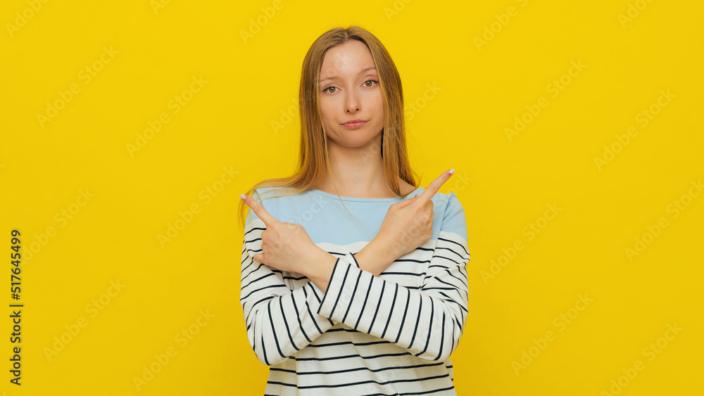 Choice, decision. Upset gloomy girl with fair-haired, sulking and frowning, pointing sideways, showing left and right, two ways, deciding, picking from variants, yellow background. Copy space Choice, decision. Upset gloomy girl with fair-haired, sulking and frowning, pointing sideways, showing left and right, two ways, deciding, picking from variants, yellow background. Copy space