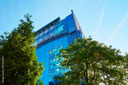 Glass facade of buiding with green trees, Modern office building in city for business corporation, Residential contemporary