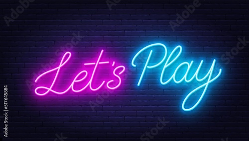 Let s Play neon sign on brick wall background.