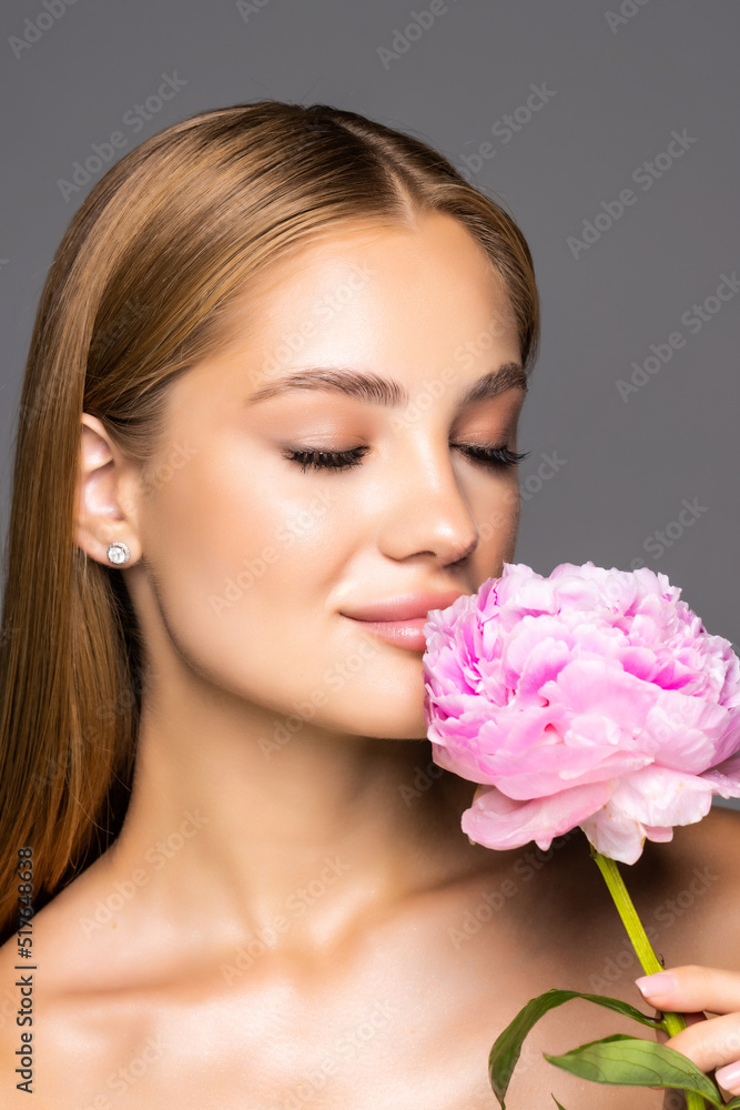 Skincare of young beautiful woman face with fresh flower over white background