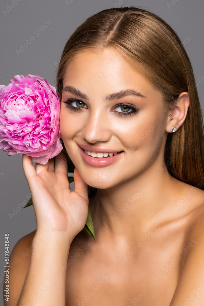 Young beautiful healthy woman with pink flower on white background Young beautiful healthy woman with pink flower on white background