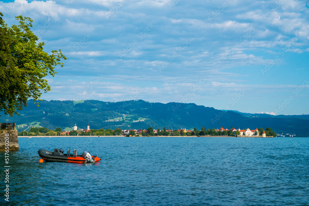 Germany, Lindau city island in warm sunset sunlight from waterside, panorama landscape view to houses and pfaender mountain at lake constance