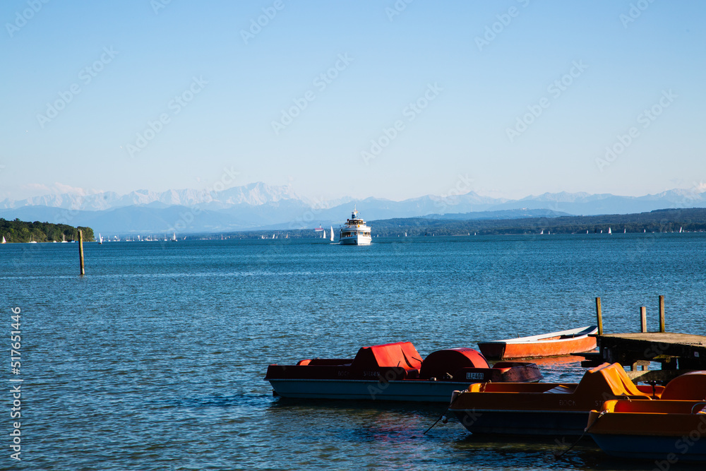 Fototapeta premium Ammersee in summer, with pedal boats and steamboat