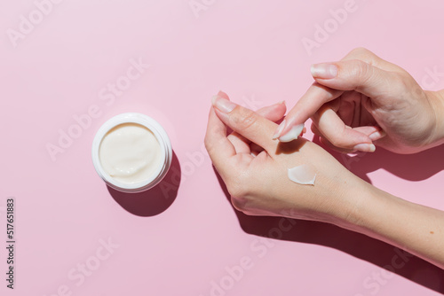 Fotografia Female applying a collagen firming cream to a hand