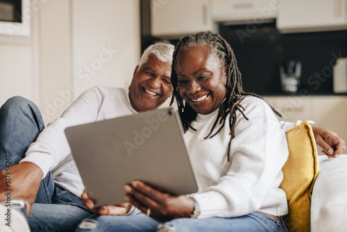 Happy senior couple having a video call at home