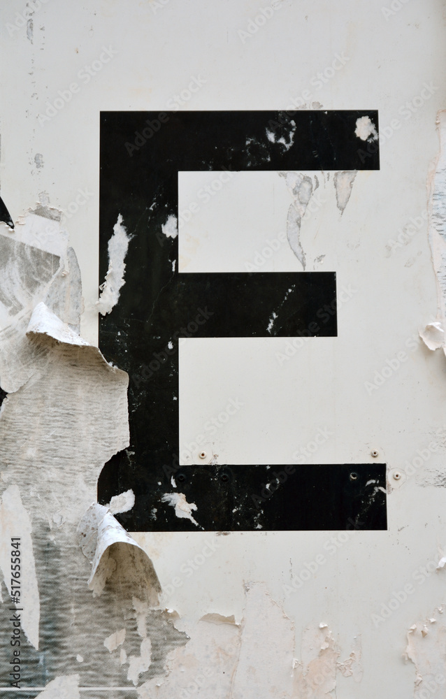 Capital Letter E on a weathered billboard