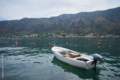 White fishing boat with an engine on a background of mountains