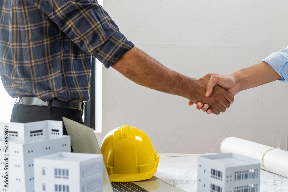 engineer, architect, construction worker team hands shaking after plan ...