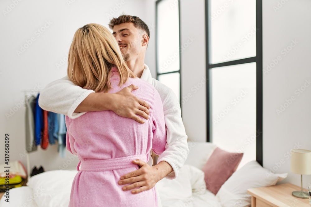 Young caucasian couple smiling happy and hugging standing at bedroom. Young caucasian couple smiling happy and hugging standing at bedroom.