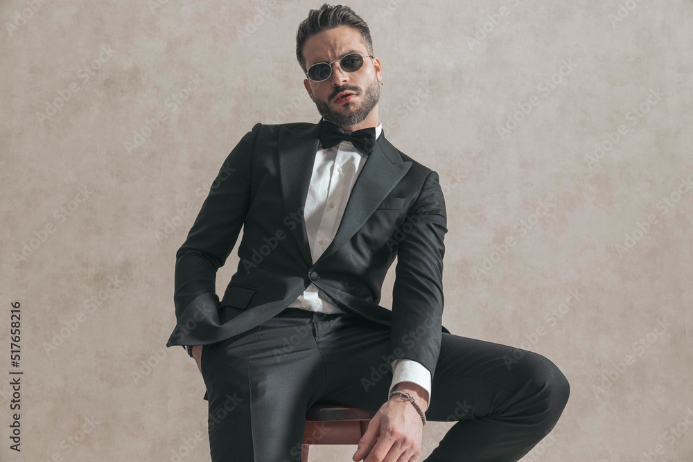 cool elegant businesmsan with hand in pocket holding arm in fashion pose cool elegant businesmsan with hand in pocket holding arm in fashion pose