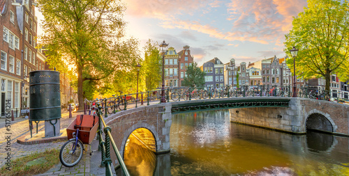 Soul of Amsterdam. Early morning in Amsterdam. Old houses, bridges, bicycles and the famous Amsterdam toilet. Panoramic view with all the sights of Amsterdam.