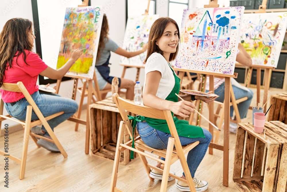 Group of women smiling happy drawing at art studio.