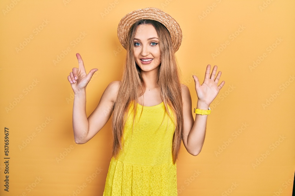 Young blonde girl wearing summer hat showing and pointing up with fingers number seven while smiling confident and happy. Young blonde girl wearing summer hat showing and pointing up with fingers number seven while smiling confident and happy.