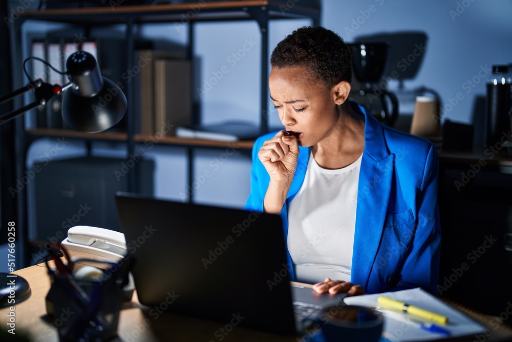 Beautiful african american woman working at the office at night feeling unwell and coughing as symptom for cold or bronchitis. health care concept. Beautiful african american woman working at the office at night feeling unwell and coughing as symptom for cold or bronchitis. health care concept.