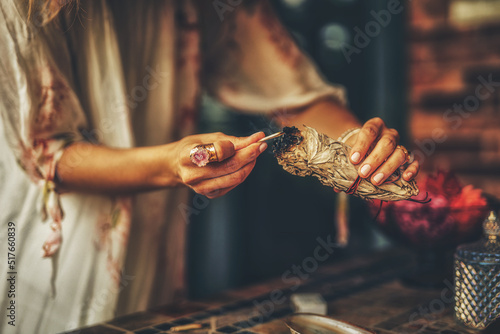 incense in a woman hand, ceremony space. photo