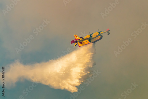 Fire plane spraying water at Geraneia mountain to eliminate the fire.