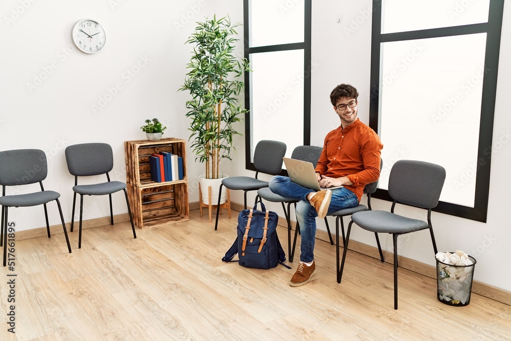Young hispanic man smiling confident using laptop at waiting room Young hispanic man smiling confident using laptop at waiting room