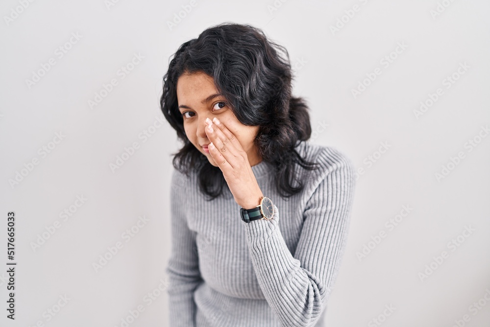 Hispanic woman with dark hair standing over isolated background hand on mouth telling secret rumor, whispering malicious talk conversation Hispanic woman with dark hair standing over isolated background hand on mouth telling secret rumor, whispering malicious talk conversation