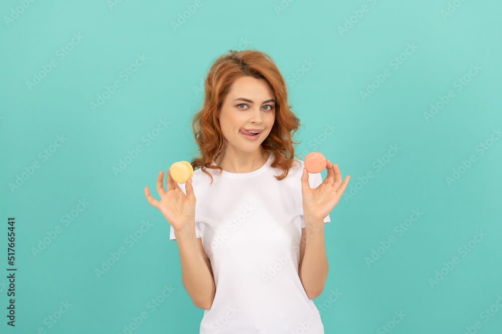 cheerful girl hold sweet macaron french cookie on blue background cheerful girl hold sweet macaron french cookie on blue background