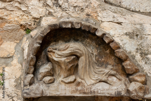 Gethsemane, a place of Jesus' prayer and vigil. Sculpture, Jesus prayed on a rock in the Garden of Gethsemane, Jerusalem, Israel.