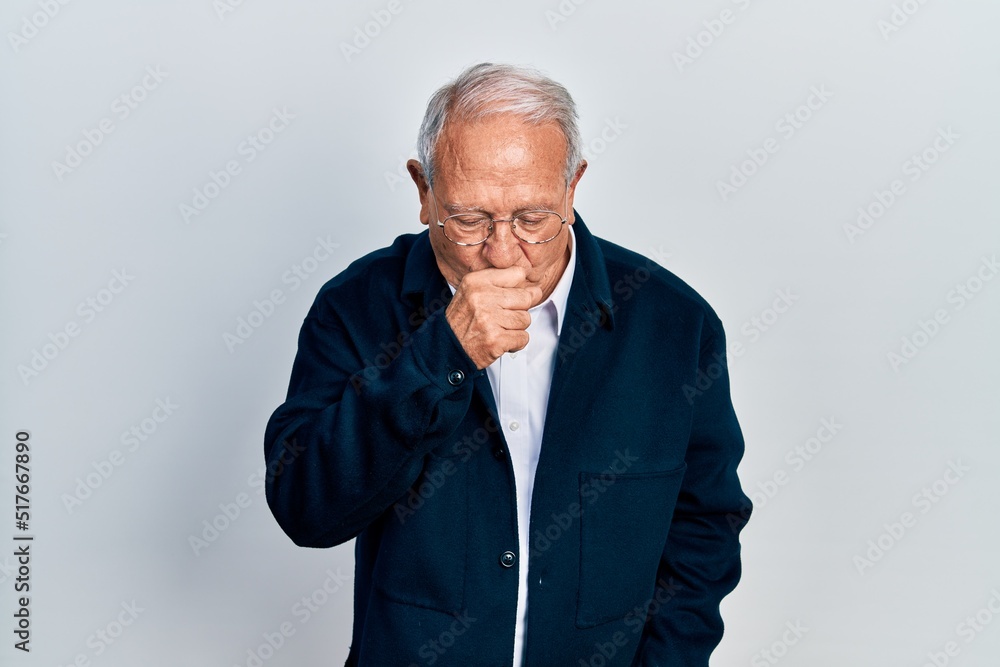 Senior man with grey hair wearing casual style and glasses feeling unwell and coughing as symptom for cold or bronchitis. health care concept. Senior man with grey hair wearing casual style and glasses feeling unwell and coughing as symptom for cold or bronchitis. health care concept.