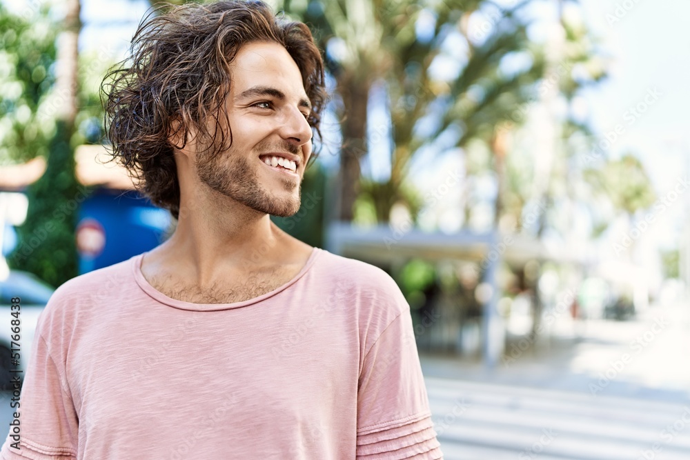 Young hispanic man smiling happy standing at street of city. Young hispanic man smiling happy standing at street of city.