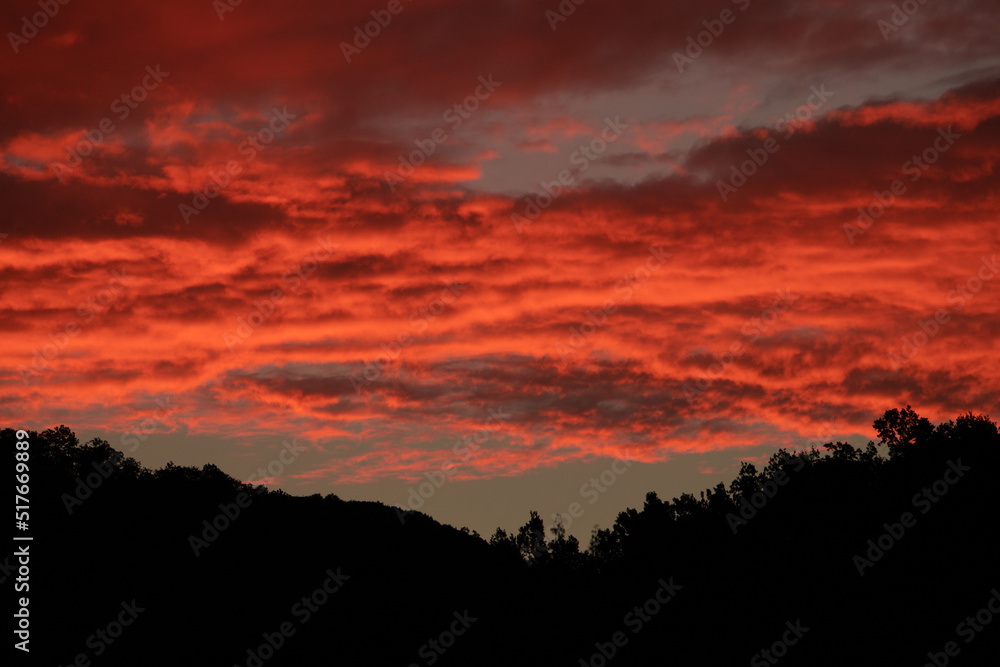 red sky after sunset over the mountains