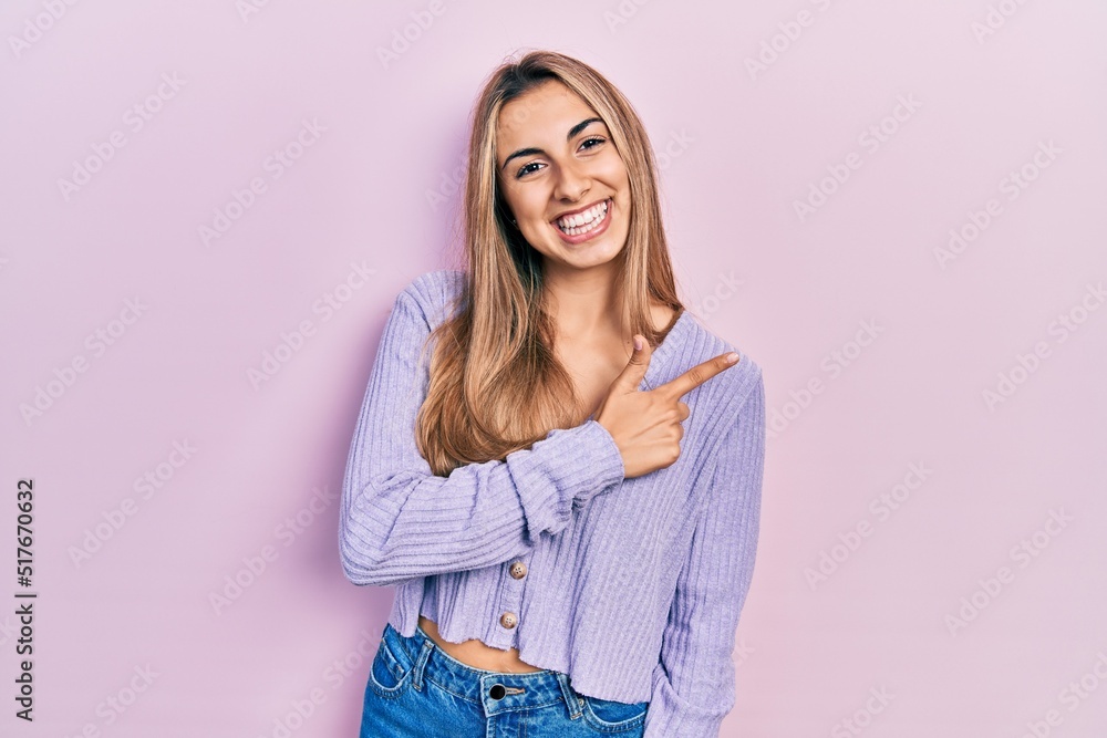 Beautiful hispanic woman wearing casual shirt cheerful with a smile of face pointing with hand and finger up to the side with happy and natural expression on face Beautiful hispanic woman wearing casual shirt cheerful with a smile of face pointing with hand and finger up to the side with happy and natural expression on face