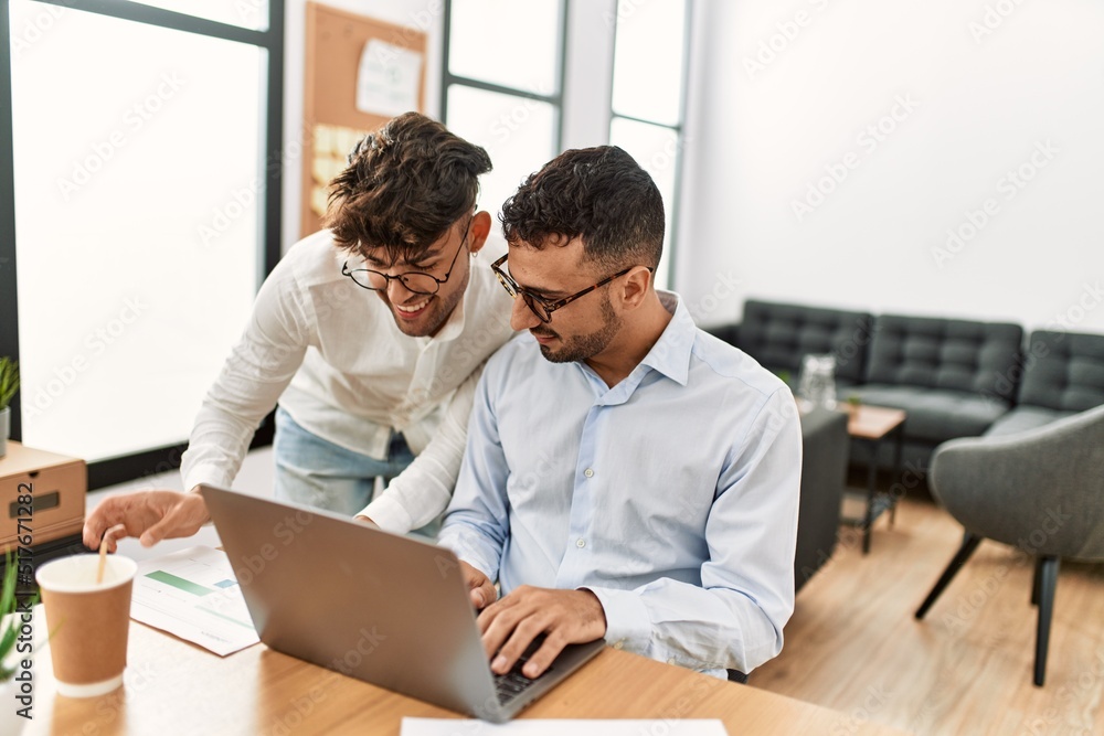 Two hispanic men business workers smiling confident working at office Two hispanic men business workers smiling confident working at office