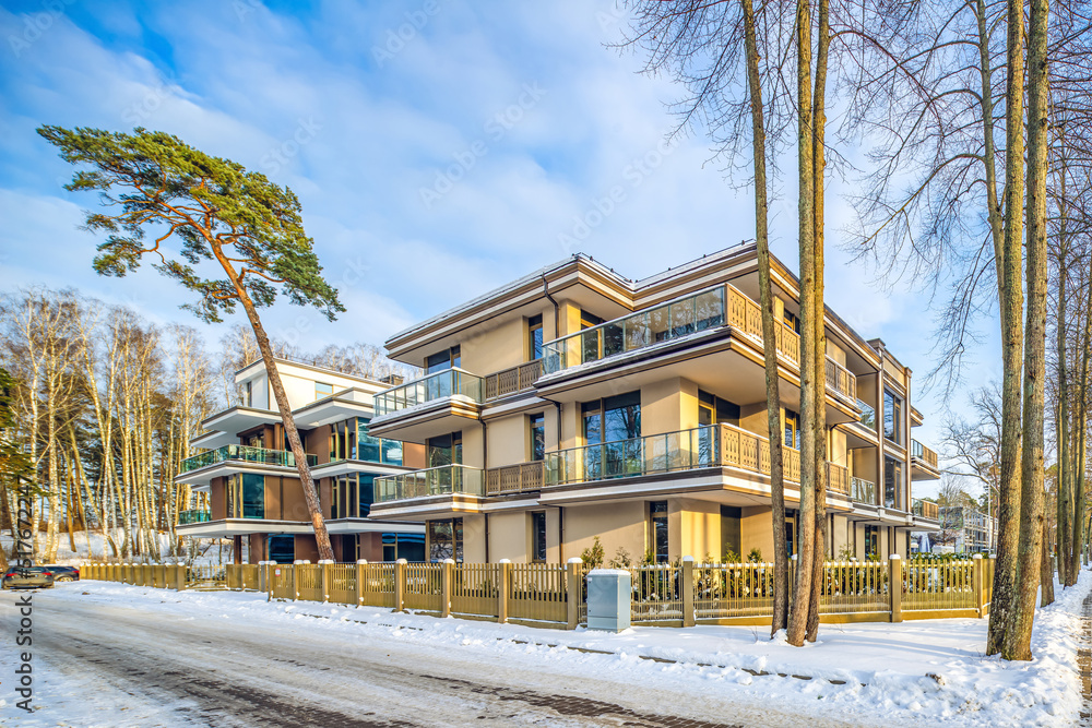 Modern exterior of new luxury residential building at winter.