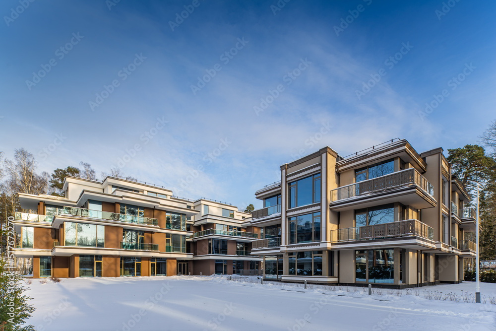Modern exterior of new luxury residential building at winter.