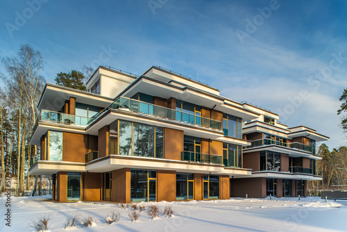 Modern exterior of new luxury residential building at winter.