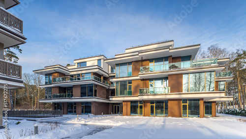 Modern exterior of new luxury residential building at winter.