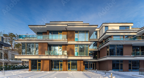 Modern exterior of new luxury residential building at winter.