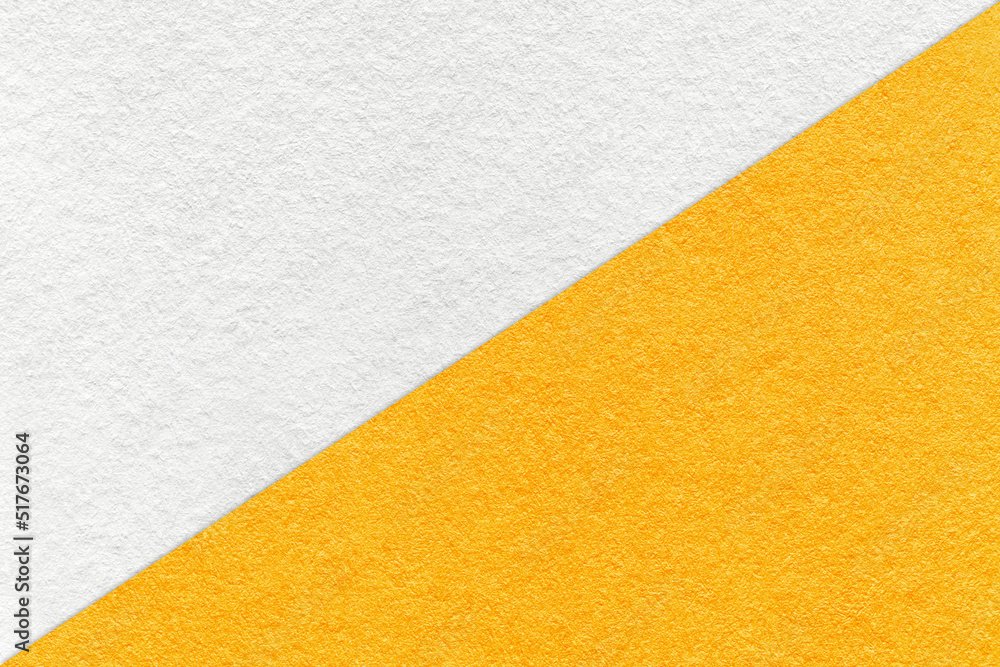 Texture of craft white and yellow paper background, half two colors, macro. Vintage dense kraft orange cardboard. Texture of craft white and yellow paper background, half two colors, macro. Vintage dense kraft orange cardboard.