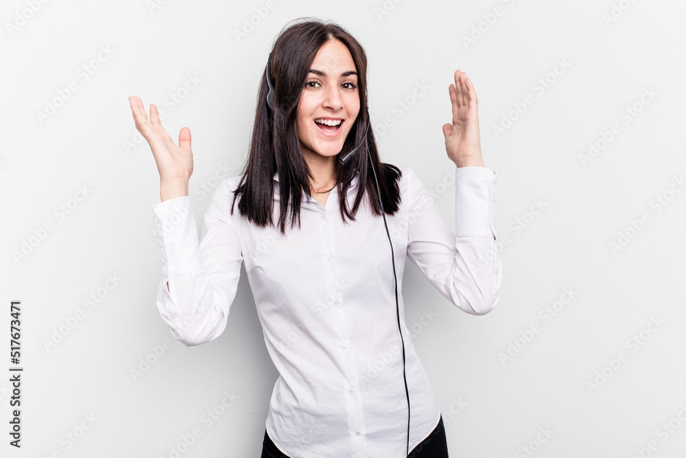 Telemarketer caucasian woman working with a headset isolated on white background receiving a pleasant surprise, excited and raising hands. Telemarketer caucasian woman working with a headset isolated on white background receiving a pleasant surprise, excited and raising hands.