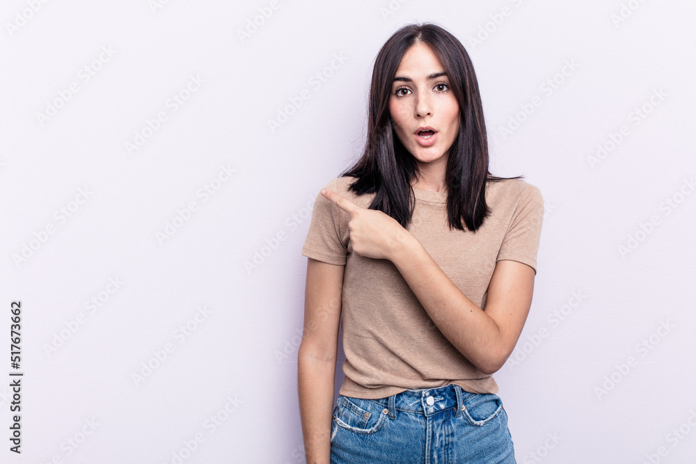 Young caucasian woman isolated on pink background pointing to the side Young caucasian woman isolated on pink background pointing to the side