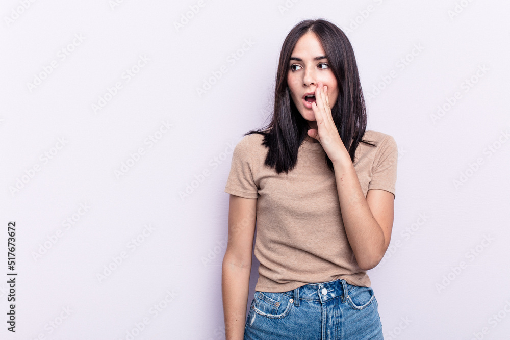Young caucasian woman isolated on pink background is saying a secret hot braking news and looking aside Young caucasian woman isolated on pink background is saying a secret hot braking news and looking aside