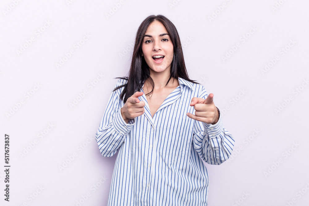 Young caucasian woman isolated on pink background pointing to front with fingers. Young caucasian woman isolated on pink background pointing to front with fingers.