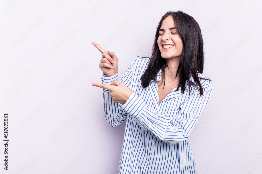 Young caucasian woman isolated on pink background excited pointing with forefingers away. Young caucasian woman isolated on pink background excited pointing with forefingers away.