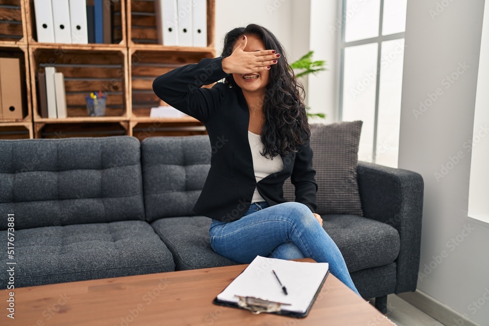 Young asian woman at consultation office smiling and laughing with hand on face covering eyes for surprise. blind concept. Young asian woman at consultation office smiling and laughing with hand on face covering eyes for surprise. blind concept.