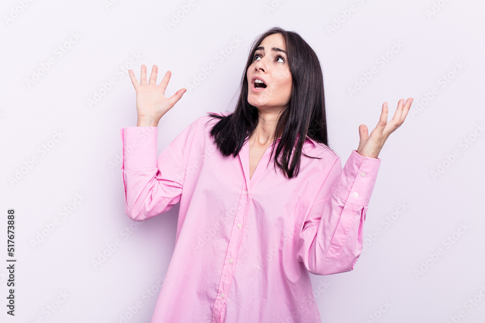 Young caucasian woman isolated on pink background screaming to the sky, looking up, frustrated. Young caucasian woman isolated on pink background screaming to the sky, looking up, frustrated.