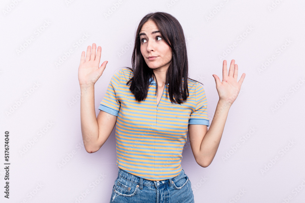 Young caucasian woman isolated on pink background being shocked due to an imminent danger Young caucasian woman isolated on pink background being shocked due to an imminent danger