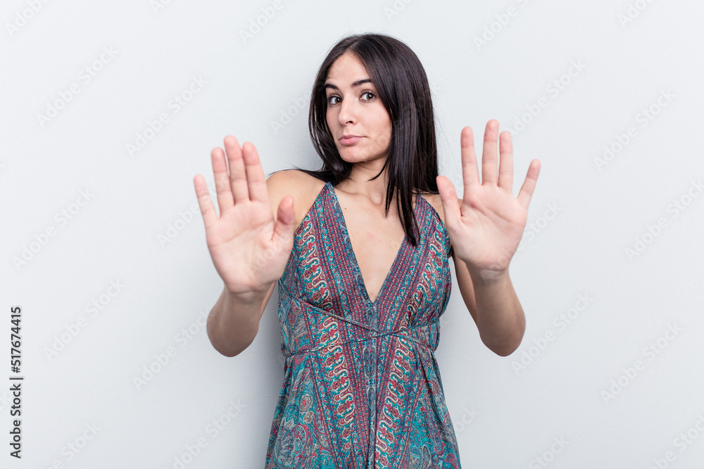 Young caucasian woman isolated on white background standing with outstretched hand showing stop sign, preventing you. Young caucasian woman isolated on white background standing with outstretched hand showing stop sign, preventing you.