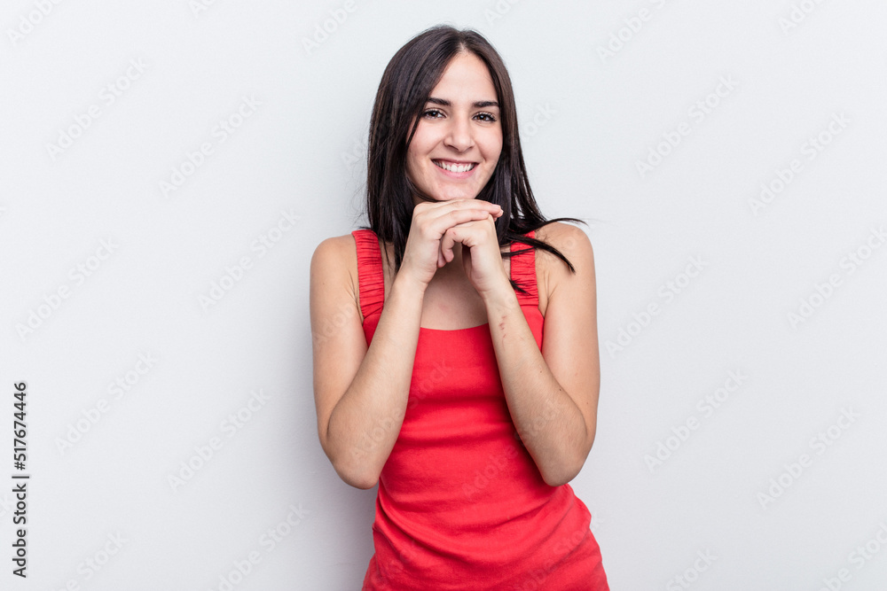 Young caucasian woman isolated on white background keeps hands under chin, is looking happily aside. Young caucasian woman isolated on white background keeps hands under chin, is looking happily aside.