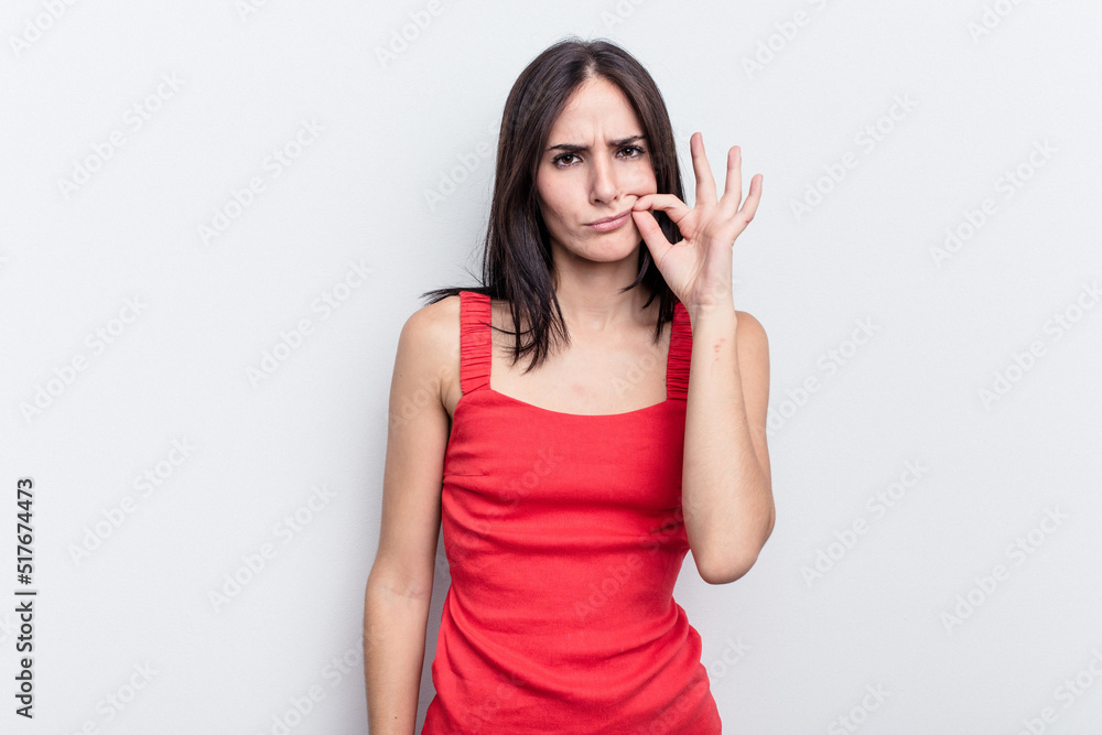 Young caucasian woman isolated on white background with fingers on lips keeping a secret. Young caucasian woman isolated on white background with fingers on lips keeping a secret.