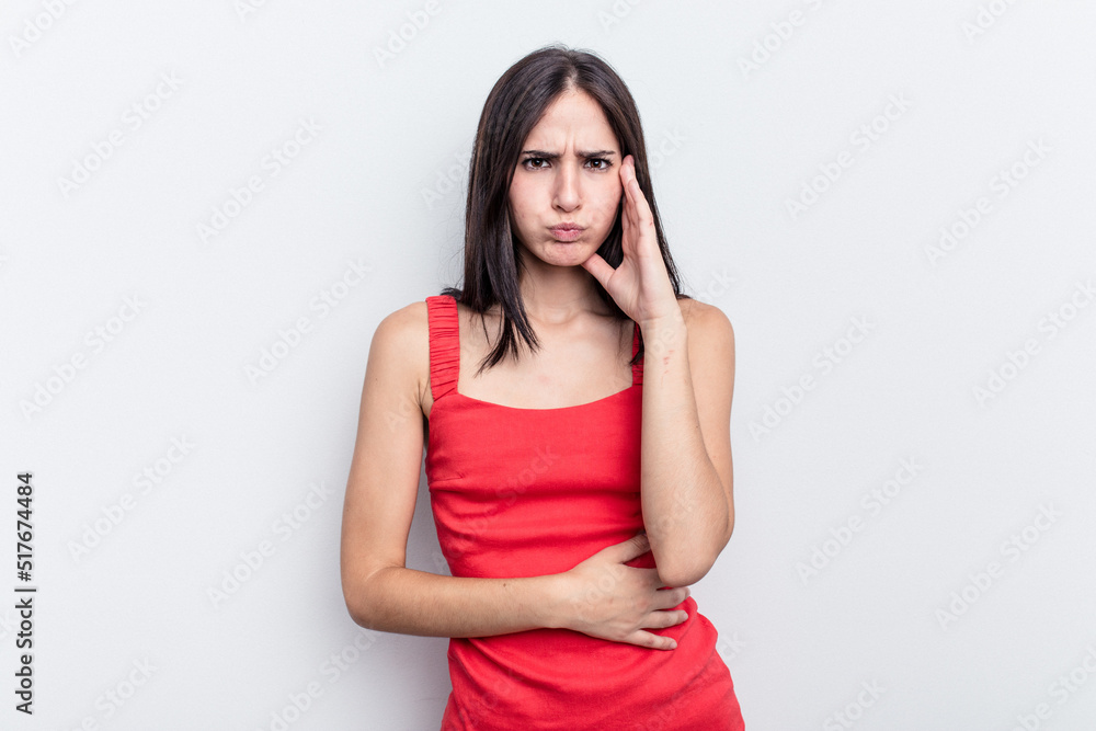 Young caucasian woman isolated on white background blows cheeks, has tired expression. Facial expression concept. Young caucasian woman isolated on white background blows cheeks, has tired expression. Facial expression concept.